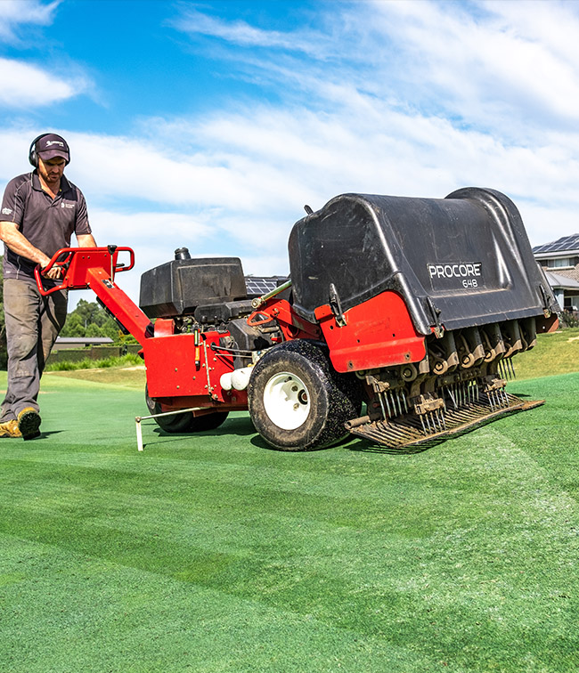 Aerating turf on golf course