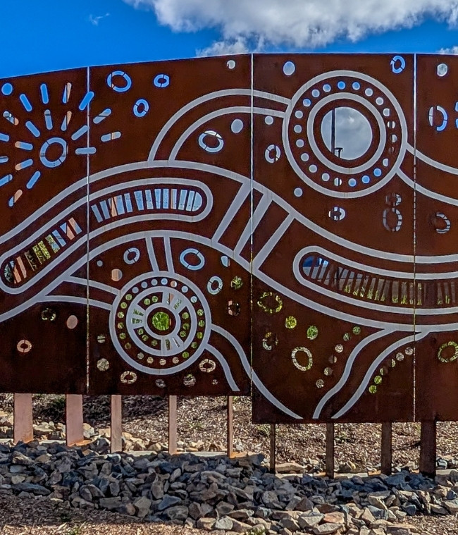 Close up, zoomed in shot of the screen panels on site demonstrating First Nations Artwork with underneath structure holding in place