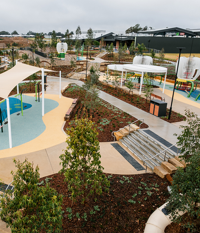 Drone view of The Gables Lake Foreshore showing an area of play equipment with connecting stairways and pathways to other areas.