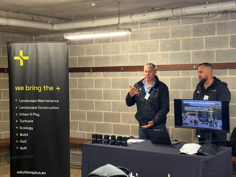 Shane Lott and Shane Burrows speaking at event with STA NSW, with solutions banner and table